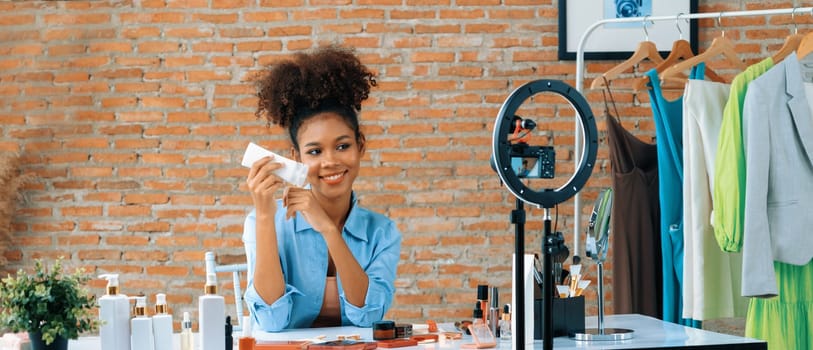 Woman influencer shoot live streaming vlog video review makeup crucial social media or blog. Happy young girl with cosmetics studio lighting for marketing recording session broadcasting online.