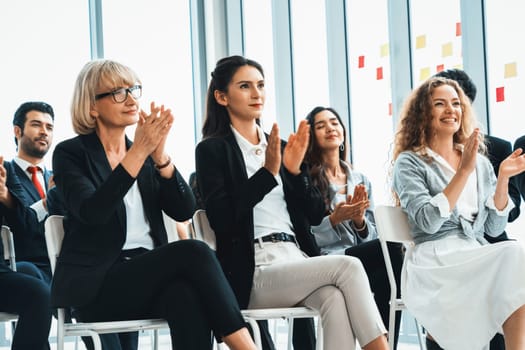 Group of business people meeting in a seminar conference . Audience listening to instructor in employee education training session . Office worker community summit forum with expert speaker . Jivy