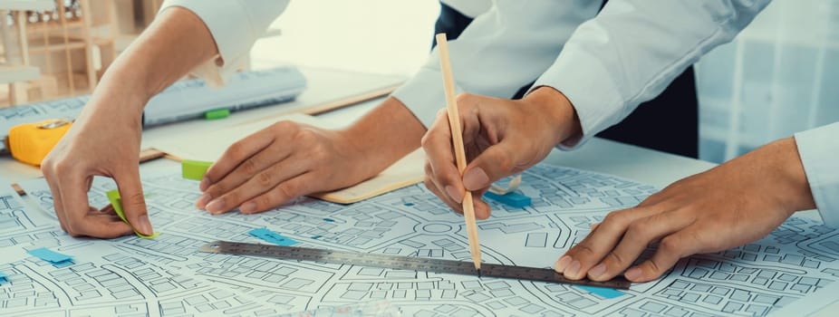 Worker, architect and engineer work on real estate construction project oratory planning with cartography and cadastral map of urban town area to guide to construction developer business plan of city