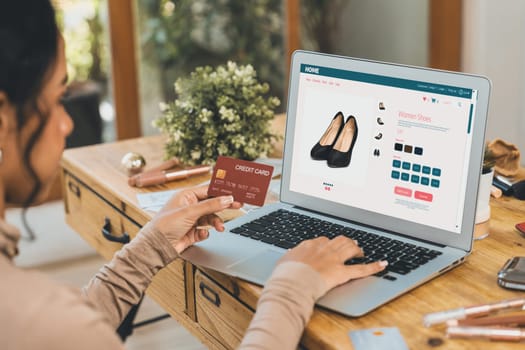 Woman shopping online on internet marketplace browsing for sale items for modern lifestyle and use credit card for online payment from wallet protected by crucial cyber security software