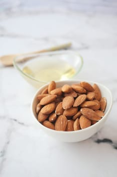 almond oils and fresh nuts on table ,