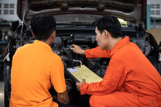 Automotive service mechanic inspect and diagnose car engine issue, repairing and fixing problem in garage workshop. Technician car care maintenance working on internal components of vehicle. Oxus