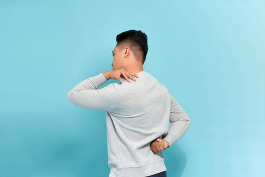 Isolated shot of a man in the back with neck and lower back pain