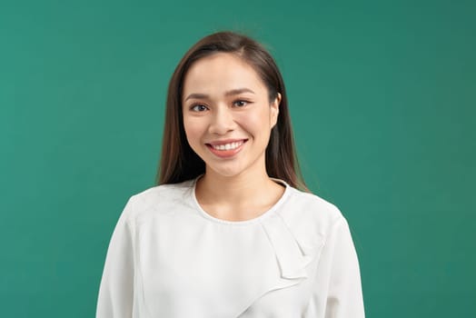 Beautiful young woman portrait, isolated on green background studio shot