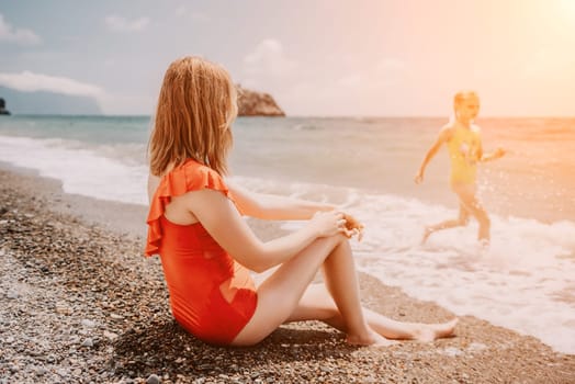 Happy loving family mother and daughter having fun together on the beach. Mum playing with her kid in holiday vacation next to the ocean - Family lifestyle and love concept.