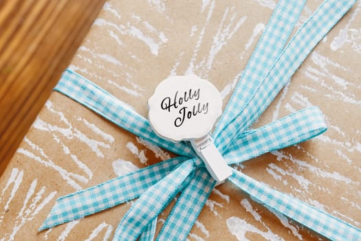 Little tag with Christmas wishes and gifts. Small label on the gift box that says Holly Jolly.