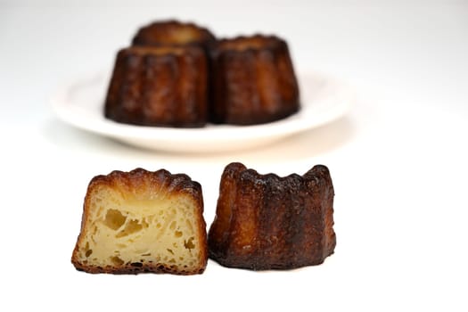 Caneles de bordeaux, traditional French sweet dessert with white table background, High quality photo
