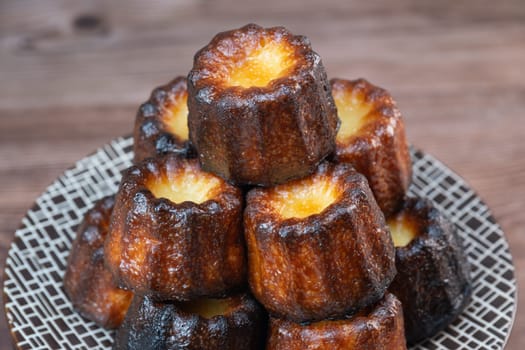 Caneles de bordeaux, traditional French sweet dessert with white table background, High quality photo