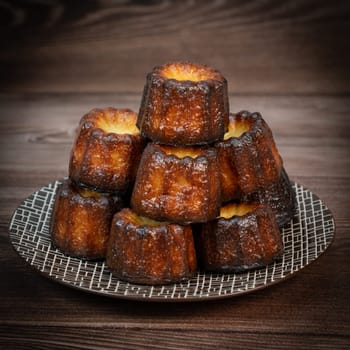 Caneles de bordeaux, traditional French sweet dessert with white table background, High quality photo