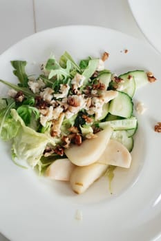 Salad with blue cheese, pears, nuts, chard and arugula.