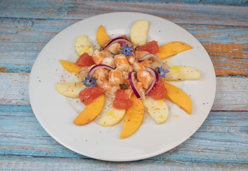 RECIPE CEVICHE OF SHRIMPS AND SCALLOPS WITH CITRUS FRUIT, LEMON, LIME, SQUEEZED ORANGE, GRAPEFRUIT AND FRUIT, PERSIMMON, APPLE, SEASONED WITH ESPELETTE PEPPER. High quality photo