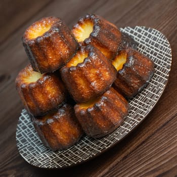 Caneles de bordeaux, traditional French sweet dessert with white table background, High quality photo