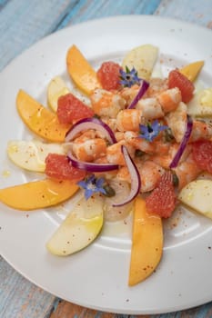 RECIPE CEVICHE OF SHRIMPS AND SCALLOPS WITH CITRUS FRUIT, LEMON, LIME, SQUEEZED ORANGE, GRAPEFRUIT AND FRUIT, PERSIMMON, APPLE, SEASONED WITH ESPELETTE PEPPER. High quality photo