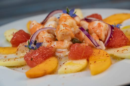 RECIPE CEVICHE OF SHRIMPS AND SCALLOPS WITH CITRUS FRUIT, LEMON, LIME, SQUEEZED ORANGE, GRAPEFRUIT AND FRUIT, PERSIMMON, APPLE, SEASONED WITH ESPELETTE PEPPER. High quality photo