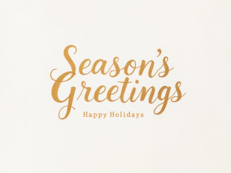 Golden calligraphic inscription season's greetings and happy holidays on an ivory background wishing happy holidays