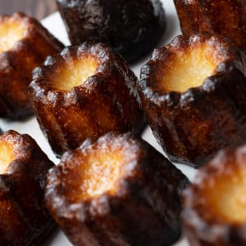 Caneles de bordeaux, traditional French sweet dessert with white table background, High quality photo