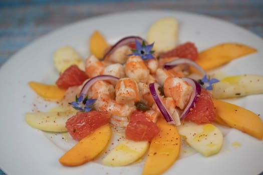 RECIPE CEVICHE OF SHRIMPS AND SCALLOPS WITH CITRUS FRUIT, LEMON, LIME, SQUEEZED ORANGE, GRAPEFRUIT AND FRUIT, PERSIMMON, APPLE, SEASONED WITH ESPELETTE PEPPER. High quality photo
