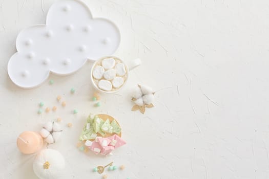Charming pastel-colored dessert setup featuring marshmallows, a cloud plate, and decor on a white background.