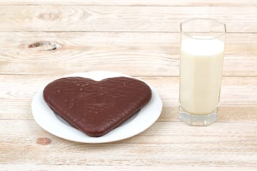 A delightful and delicious chocolate heartshaped snack that is perfectly accompanied by a refreshing glass of milk