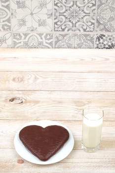 A delicious and decadent heartshaped chocolate cake, perfectly complemented by a refreshing glass of milk