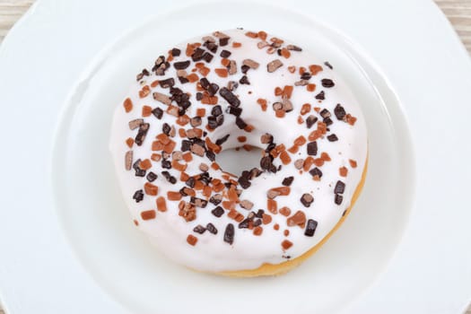 Enjoy a delicious donut topped with creamy icing and sprinkled with delightful chocolate bits in every bite