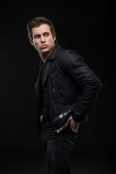 Charming sexy brunet in jeanswear profile shot in the dark room