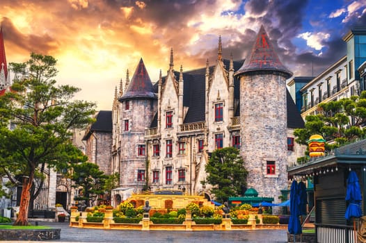 medieval beautiful castle on a square in a French village in Ba Na Hills Park in Da Nang, Vietnam at sunset