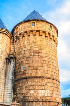 stone tower of a medieval old castle in Europe against the sky
