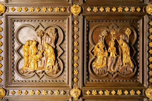 Florence, Italy, January 5, 2024: Saint John the Baptist baptizes Christ. Original door of the baptistery with stories of Saint John the Baptist. South door. Andrea Pisano