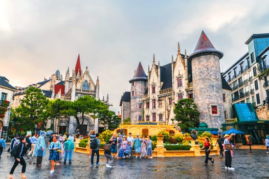 The central square of the medieval stone town with a Catholic cathedral and a castle in Ba Na Hills Park. Da Nang, Vietnam - September 13, 2024
