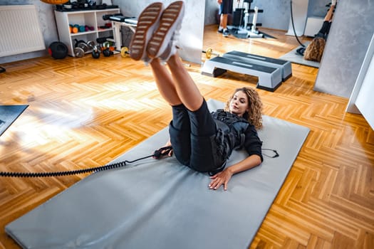 A person engages in a full-body workout with electrical stimulation equipment.
