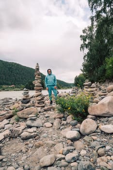Man at the river Katun at summer day. Trip on Altai Mountains in Altai Republic