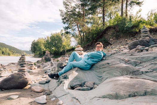 Man at the river Katun at summer day. Trip on Altai Mountains in Altai Republic