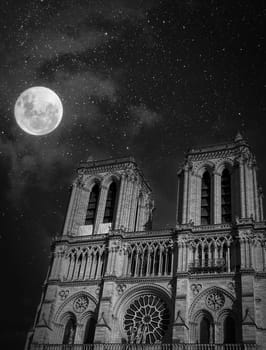 Notre dame cathedral, Paris on a cloudy evening with moon and stars, High quality photo