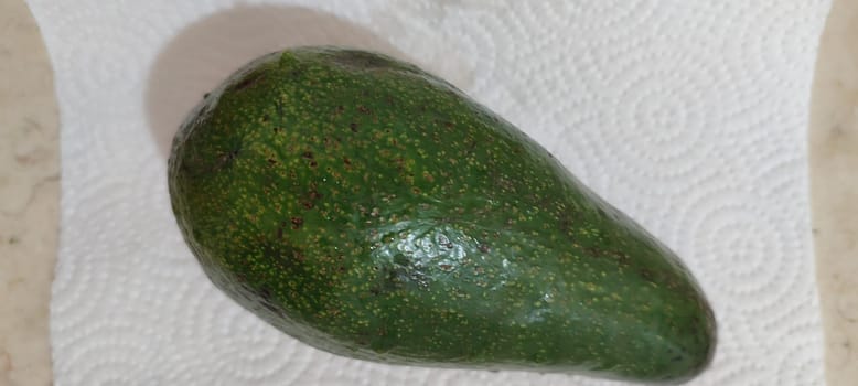 green avocado, fruit, healthy food, white background closeup . High quality photo