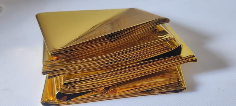 thin gold foil aluminum blanket background AliExpress souvenir texture, emergency blanket, abstract object on white background