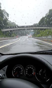 Safe journey: vehicle cautiously navigating a damp roadway, emphasizing the importance of driving safety and vehicle control on slippery surfaces while adapting to challenging wet road conditions
