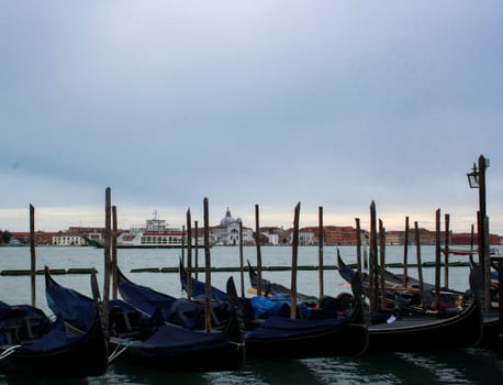 Gondolas in the foreground with the Basilica of San Giorgio in the background, Venice.Wallpaper, background for tourism advertisements and brochures.Copy space .Real picture