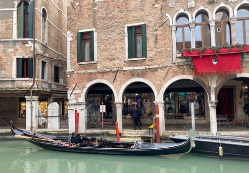 Traditional Venezian street gondola in Venice, Italy.Horizotal wallpaper.Background for tourist advertising and brochures. Real image. Winter tourism in Italy