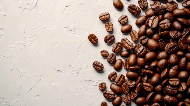Brown coffee beans are spread across a plain white background.