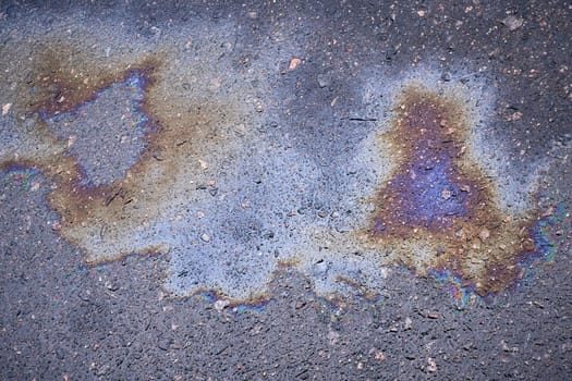 Multicolored oil stains on asphalt, mesmerizing artistic background
