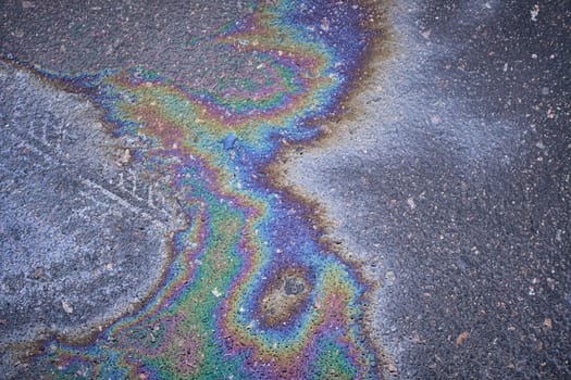 Oil residue glistens on the asphalt, adding an intriguing texture to the scene.