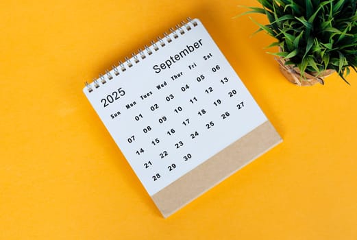 September 2025 desk calendar on yellow background. Directly above. Flat lay. Copy space.
