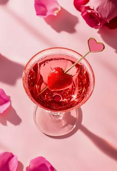 A charming Valentine's Day cocktail with bright red shades, decorated with a slice of strawberry in the shape of a heart.