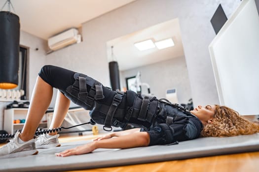 A person uses electronic muscle stimulation for a unique workout.