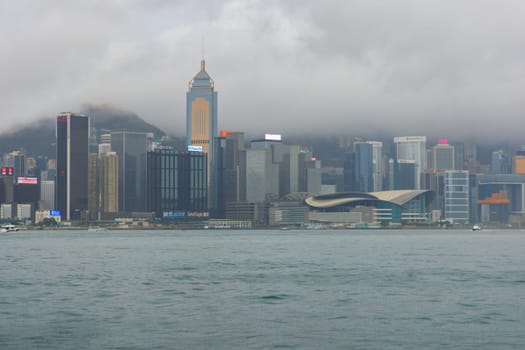 Hong Kong - September 4, 2023: Clouds and rain over city skyline at dusk. High quality photo