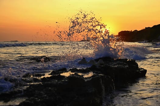 Beautiful sunset on the beach with the sea. Waves on the sea. Greece - Corfu island (Kerkyra) Agios Georgios. A concept for travel, holidays and summer vacations. 