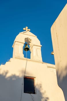 Greek church with anti-pigeon device and rusty bronze bell