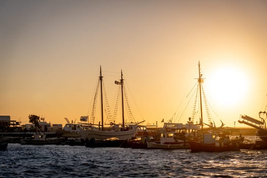 Pleasure boats in the old port of Mykonos at sunset