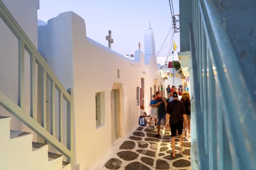 Unknown people coming and going on a narrow street in Mykonos